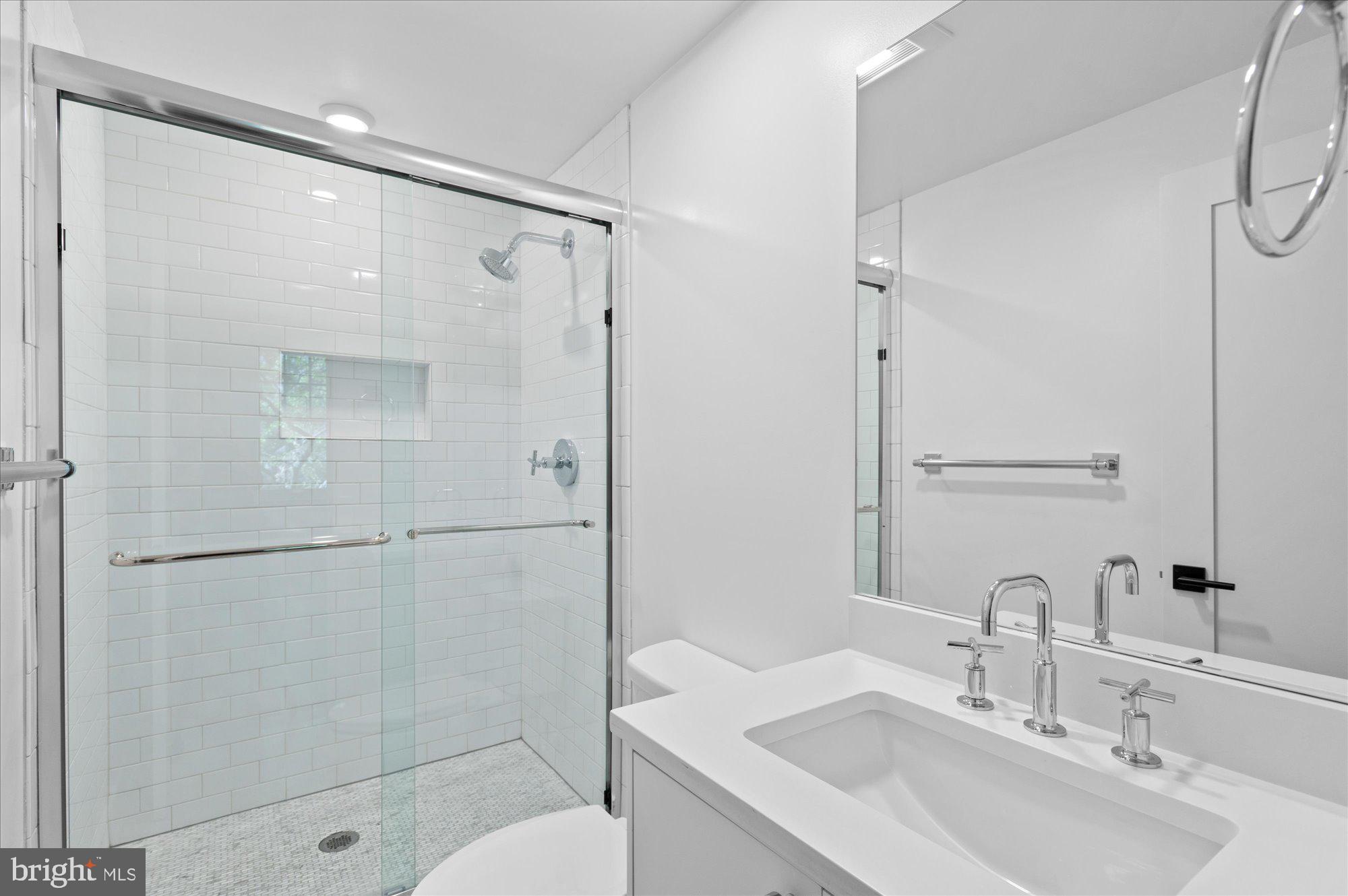 2869 28th Street Northwest, Unit 301 Washington, DC 20008 - Photo 19 of 31 a bathroom with a sink toilet and shower