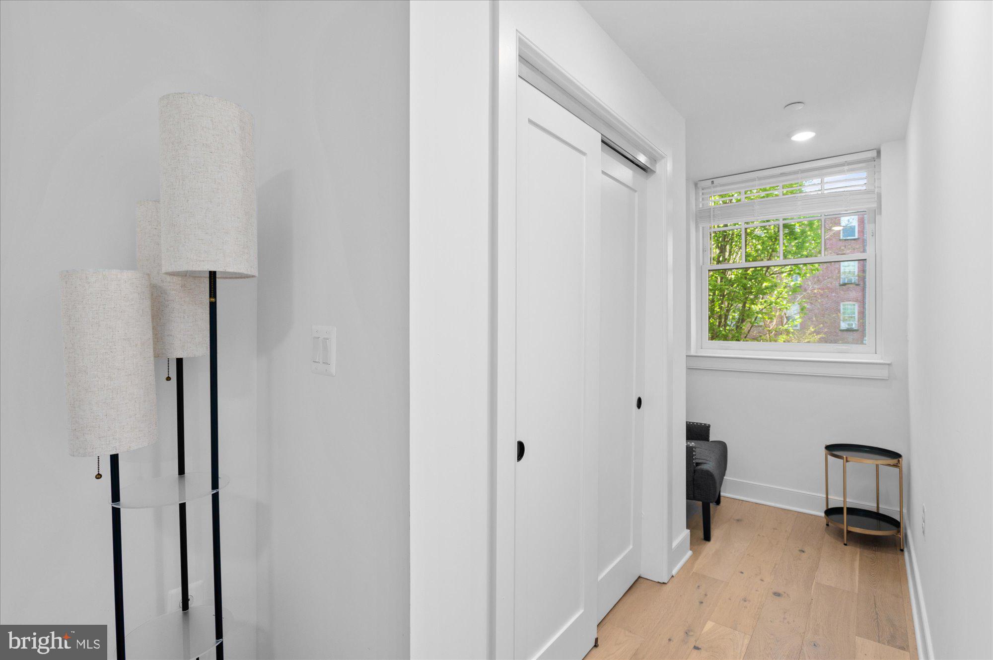 2869 28th Street Northwest, Unit 301 Washington, DC 20008 - Photo 21 of 31 a view of a hallway with a window and a bathroom
