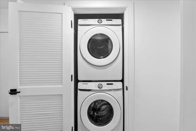 a view of a hallway with washer and dryer