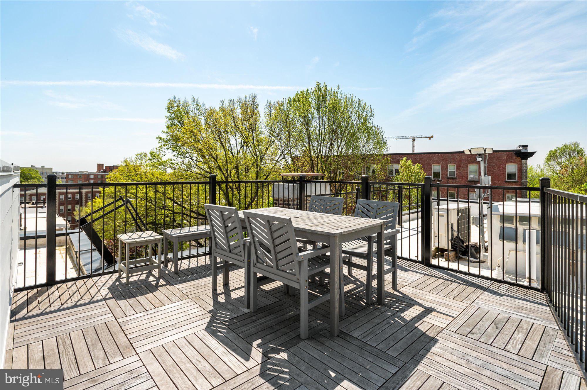 2869 28th Street Northwest, Unit 301 Washington, DC 20008 - Photo 25 of 31 a view of a chairs and table on the roof deck