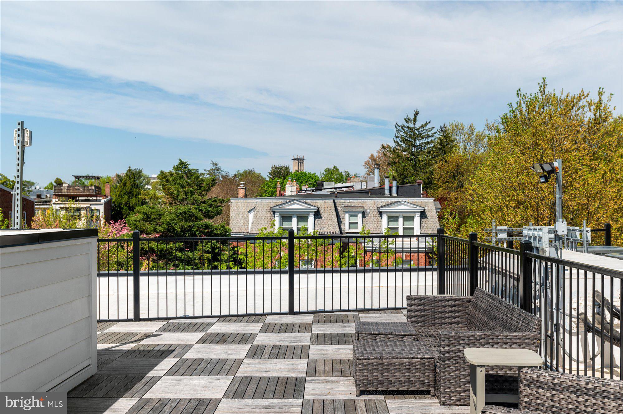 2869 28th Street Northwest, Unit 301 Washington, DC 20008 - Photo 30 of 31 a view of a brick house with a small yard and wooden fence