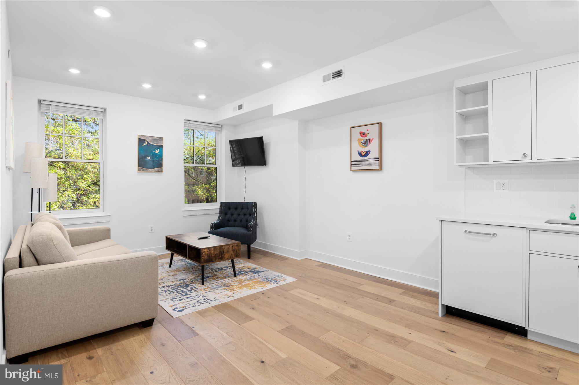 2869 28th Street Northwest, Unit 301 Washington, DC 20008 - Photo 10 of 31 a living room with furniture and a window