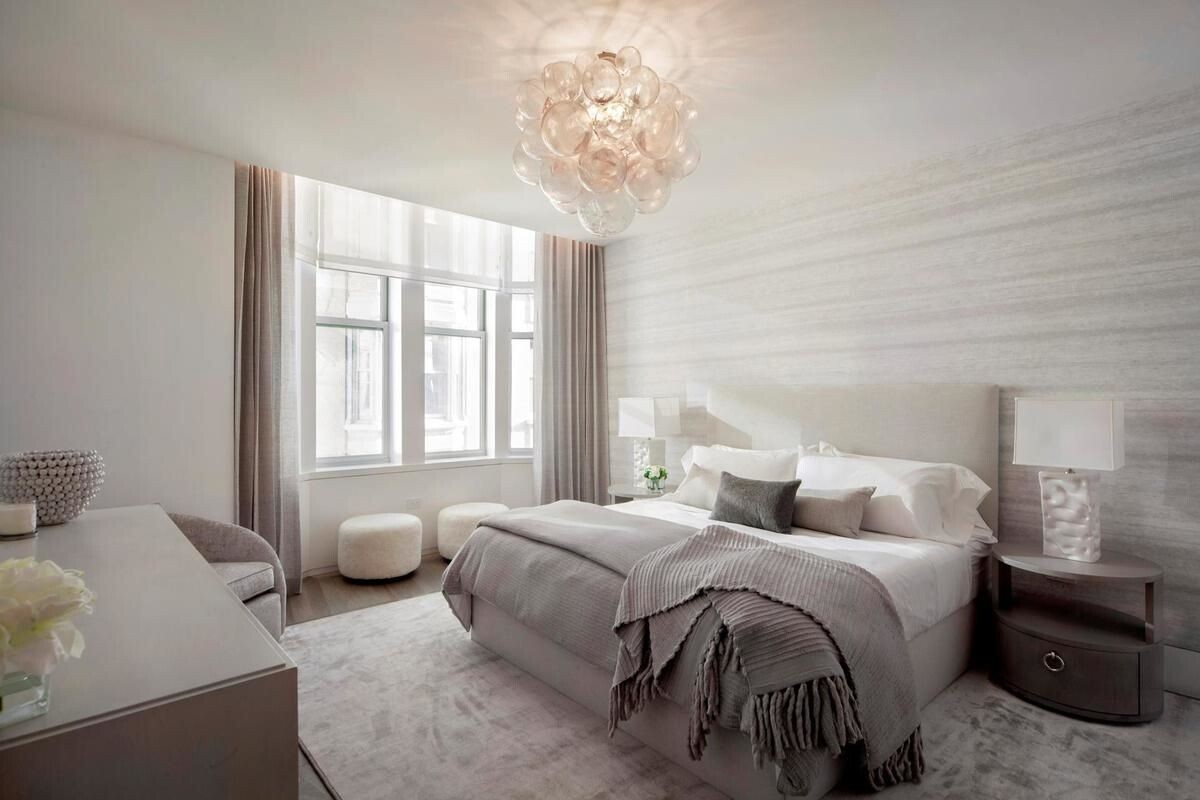 49 Chambers Street, Unit 16C Manhattan, NY 10007 - Photo 3 of 19 a bedroom with a bed and a chandelier