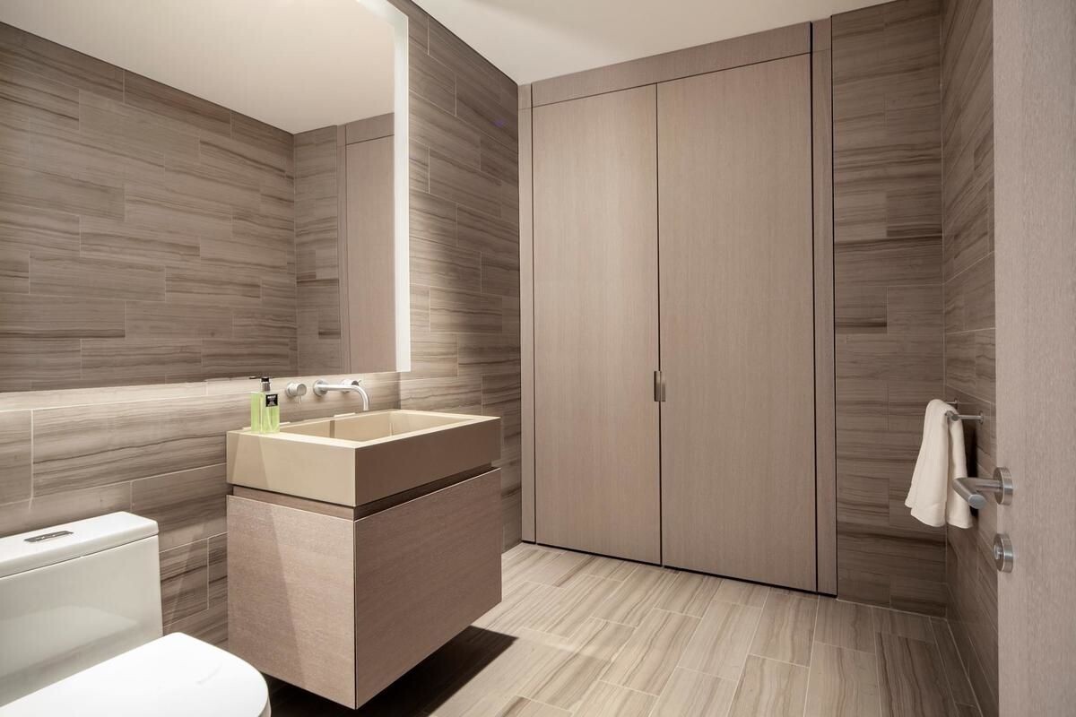 49 Chambers Street, Unit 16C Manhattan, NY 10007 - Photo 6 of 19 a bathroom with a sink toilet and shower