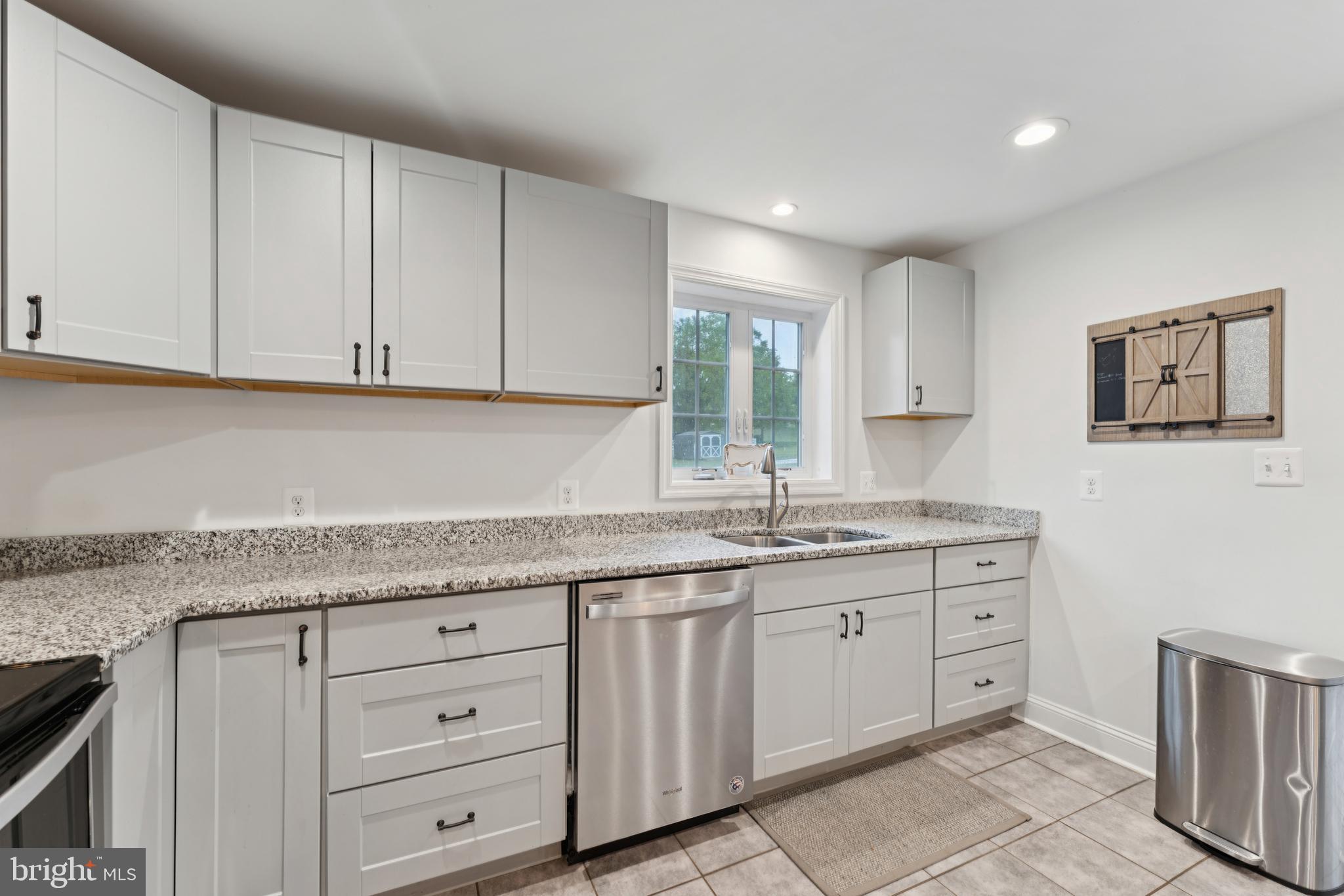 2372 Mayberry Road Westminster, MD 21158 - Photo 11 of 38 a kitchen with granite countertop white cabinets and sink