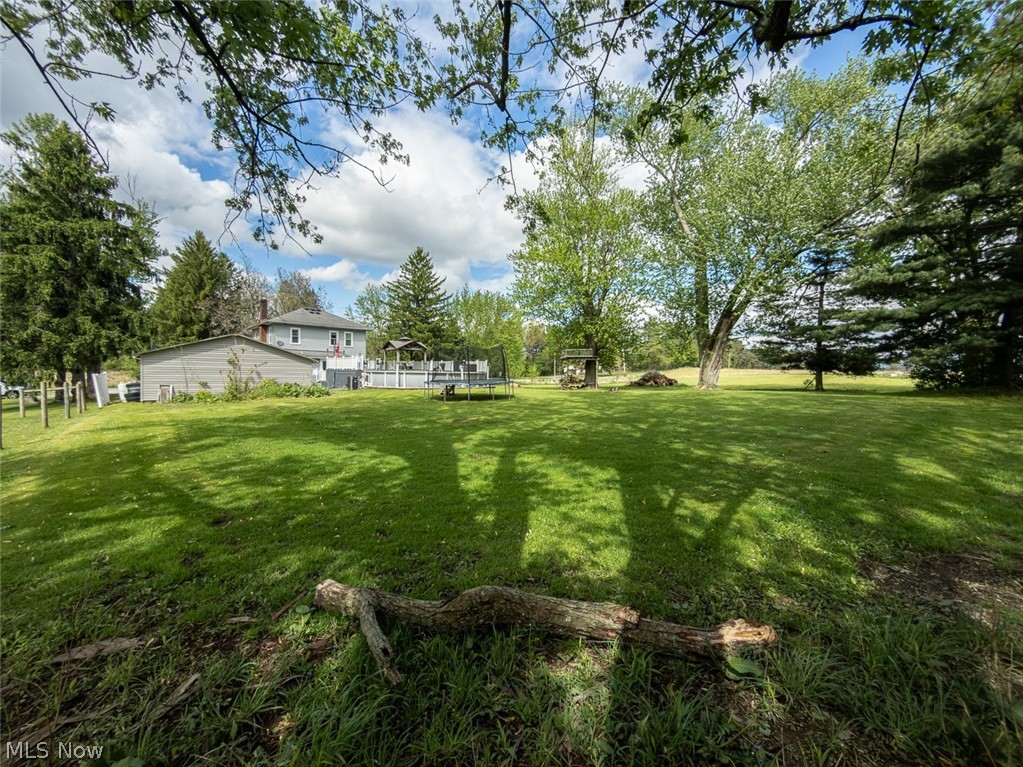 13429 West Calla Road Salem, OH 44460 - Photo 26 of 27 Expansive rear lawn featuring mature trees and a detached structure
