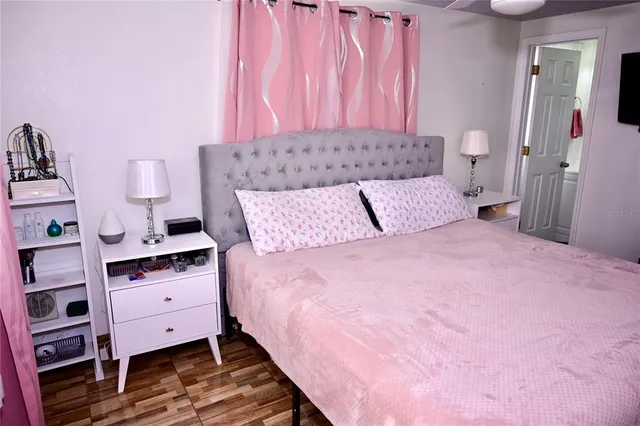 a bedroom with a bed and a dresser