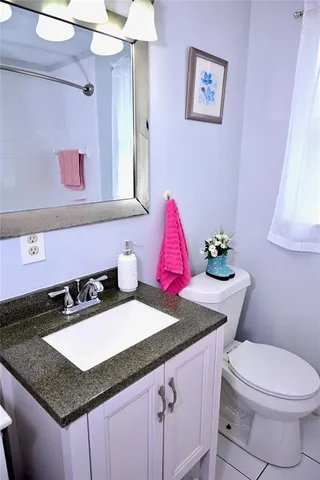 a bathroom with a sink a vanity and a toilet
