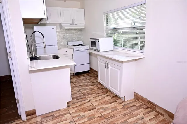 a utility room with sink dryer and washer