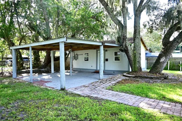 a view of a small house with backyard
