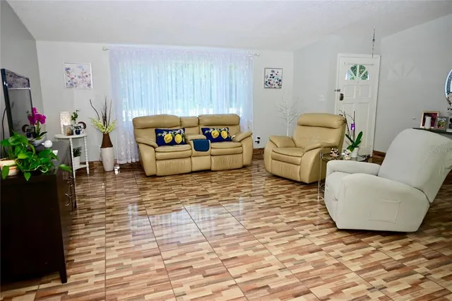 a living room with furniture and a potted plant