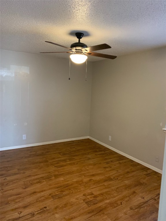 6504 South 1st Street, Unit 104 Austin, TX 78745 - Photo 4 of 5 a view of empty room with wooden floor