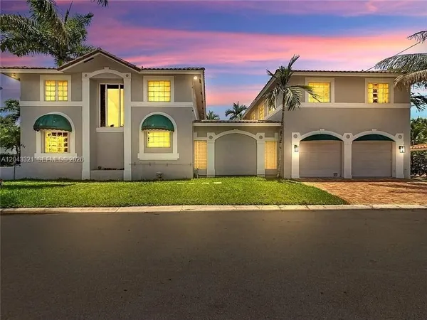 a front view of a house with a garden