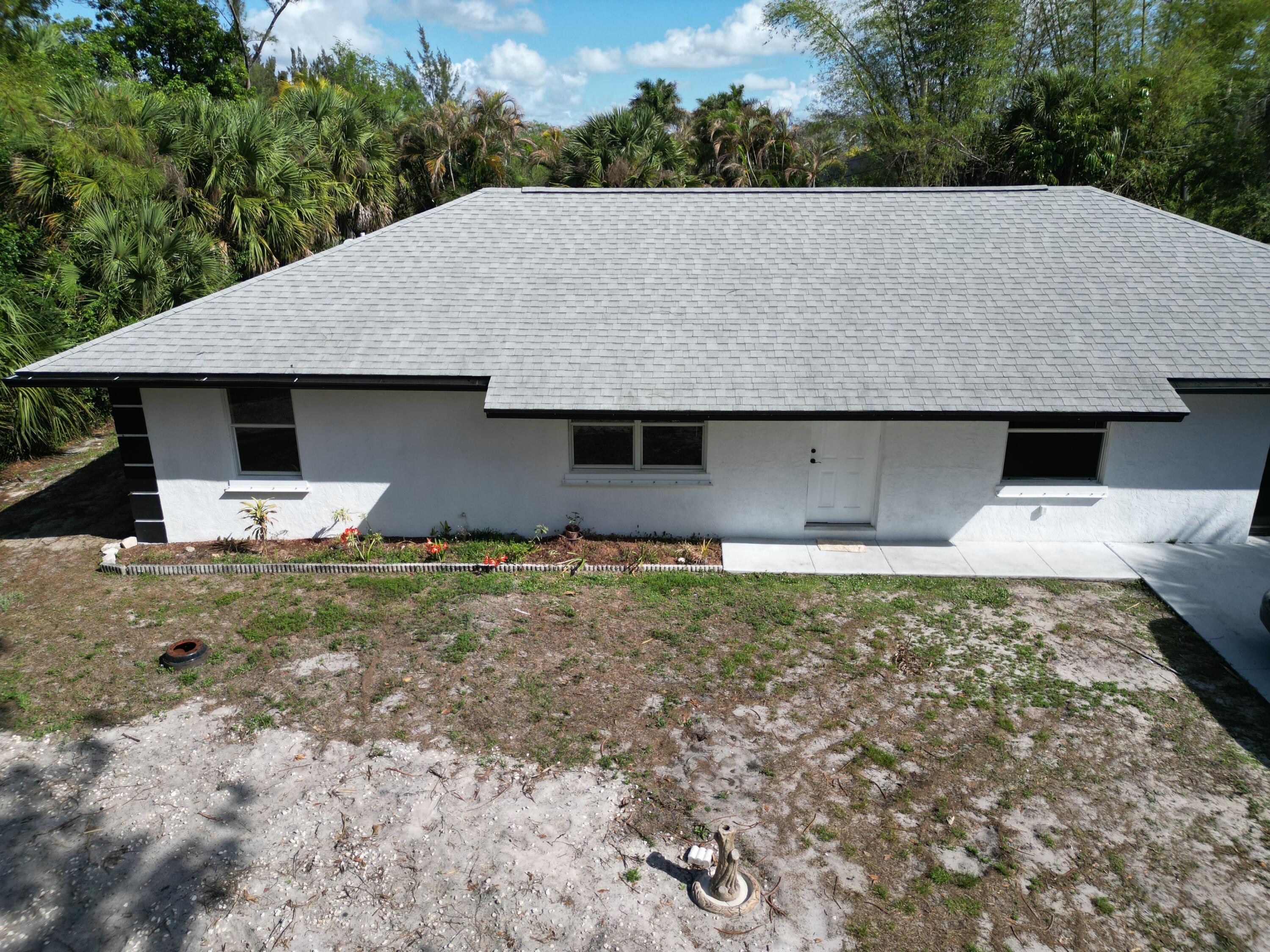 14523 Flamingo Road Loxahatchee Groves, FL 33470 - Photo 5 of 50 a house view with a garden space