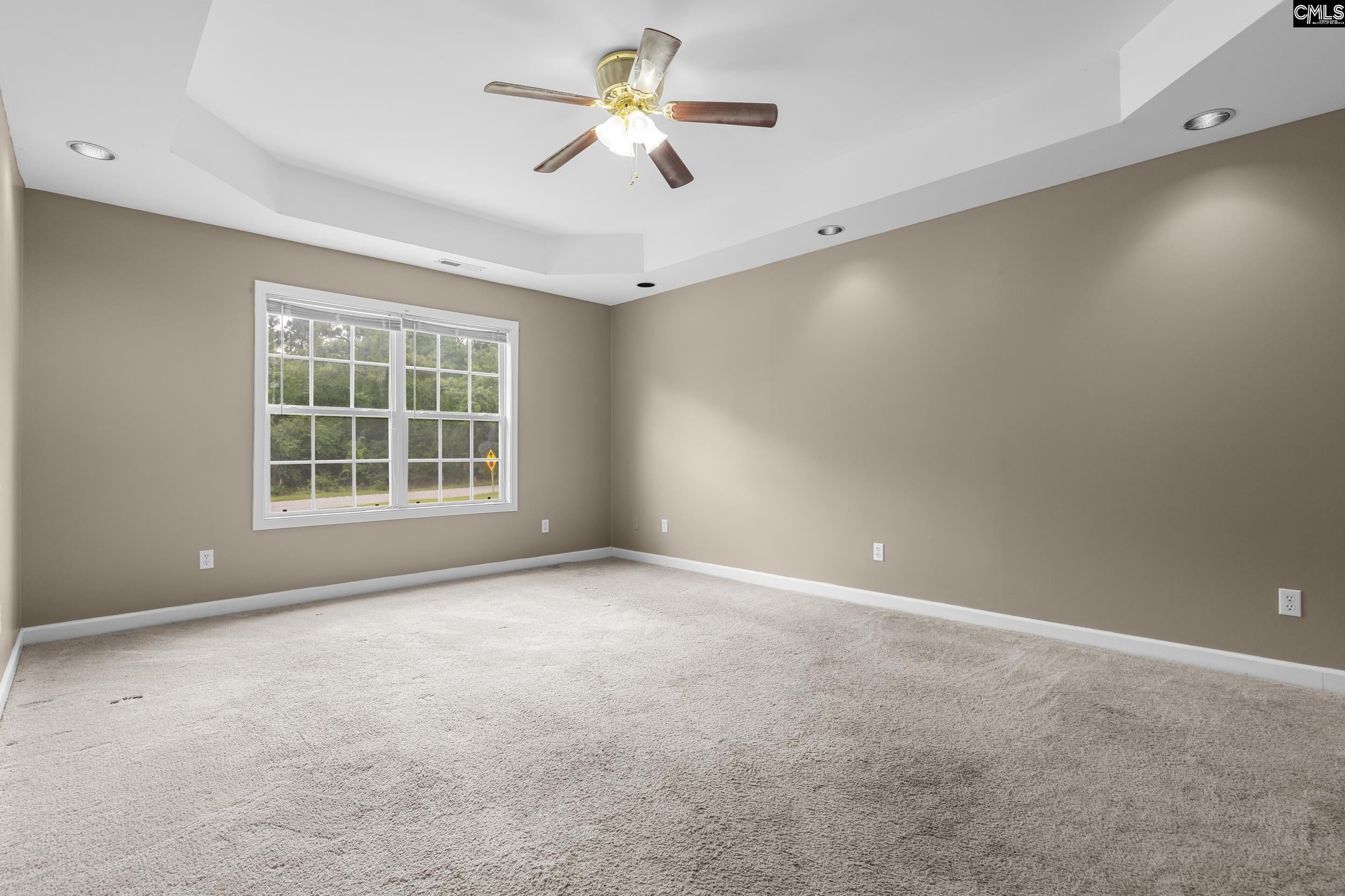 548 Eskie Dixon Road Elgin, SC 29045 - Photo 12 of 27 an empty room with a window and a ceiling fan
