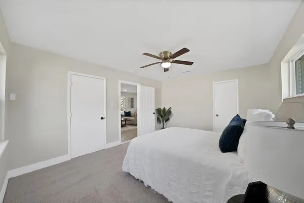 a view of a hallway with wooden floor fireplace and living room