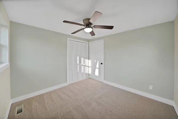a spacious bathroom with a toilet sink and shower