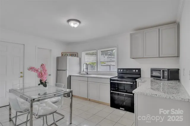 a kitchen with stainless steel appliances granite countertop a stove a sink dishwasher and a refrigerator