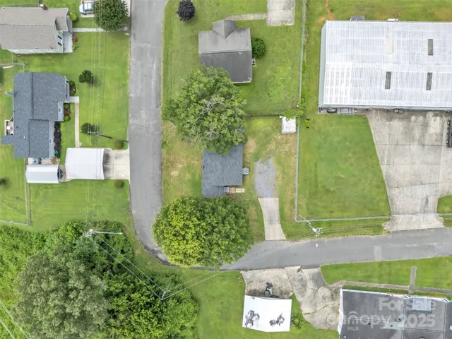 an aerial view of a residential houses with outdoor space