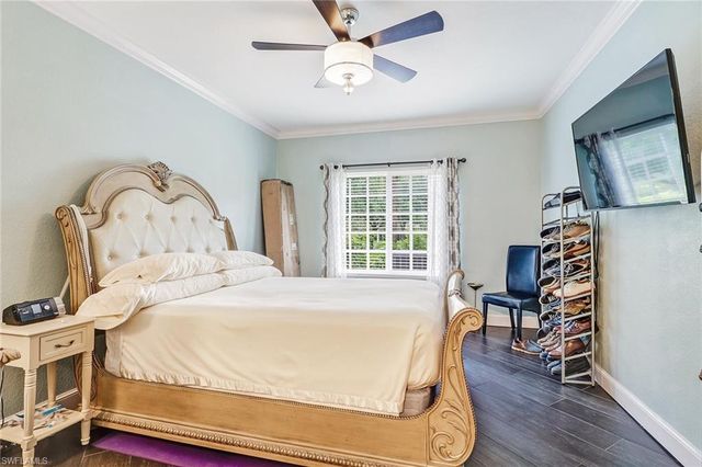 a bedroom with a bed a window and chair