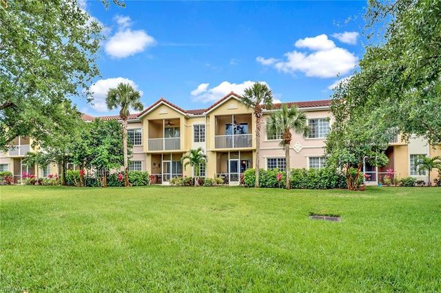 a front view of a building with a garden