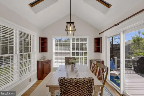 a view of a livingroom with furniture wooden floor and windows