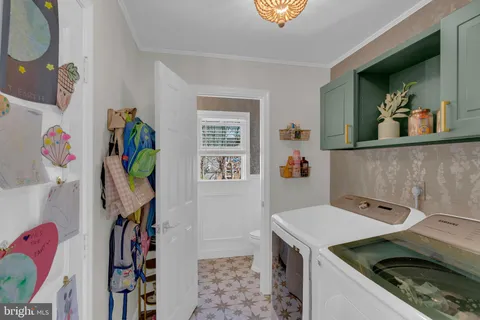 a utility room with a sink dryer and washer
