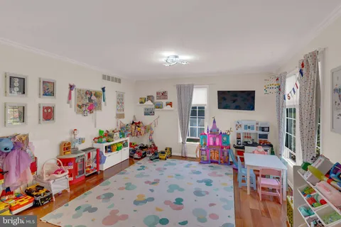 a bed room with furniture and a flat screen tv