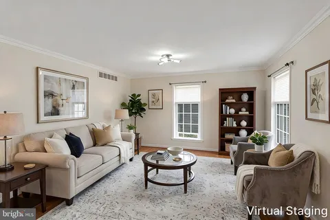 a living room with furniture potted plant and window