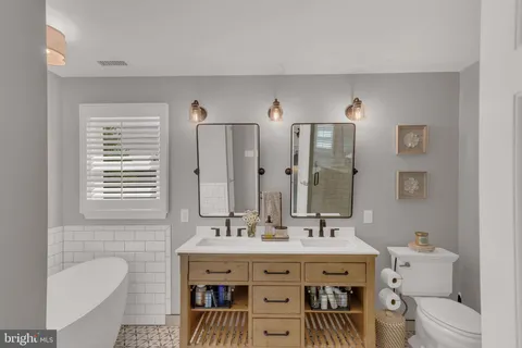a spacious bathroom with a sink double vanity and a bathtub