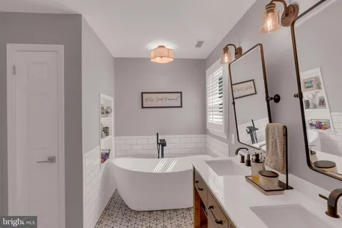 a bathroom with a sink mirror and a bathtub