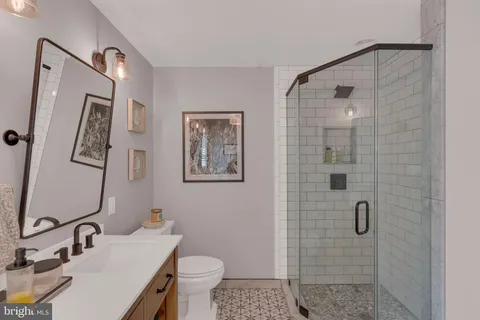 a bathroom with a sink toilet and shower