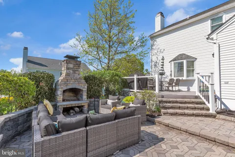 a view of a patio with couches chairs and a fire pit