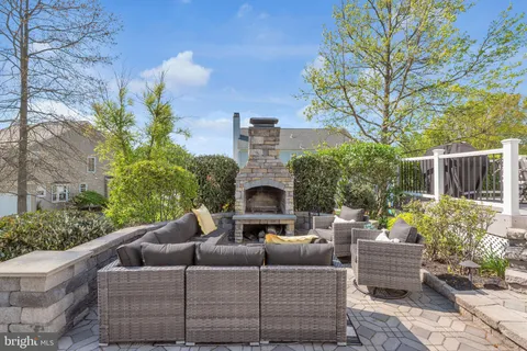 a view of a patio with couches table and chairs and potted plants