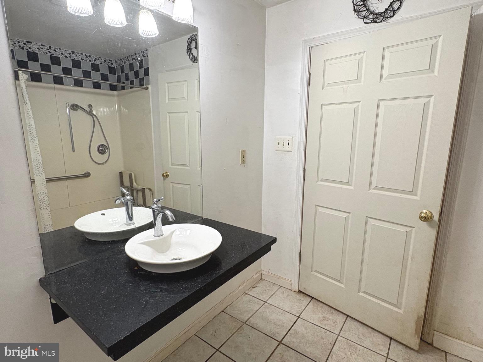 4215 Buffalo Road Mount Airy, MD 21771 - Photo 16 of 44 a bathroom with a sink a mirror and a shower