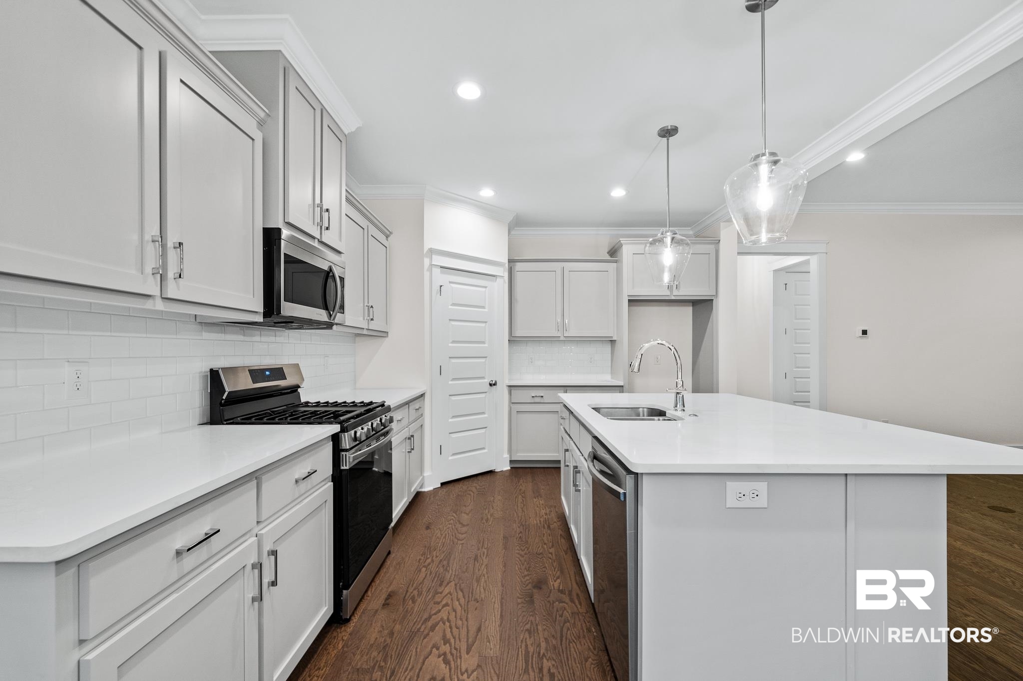29 Signal Hill Road Daphne, AL 36527 - Photo 13 of 36 Kitchen featuring a center island with sink, stainless steel appliances, sink, and dark hardwood / wood-style floors