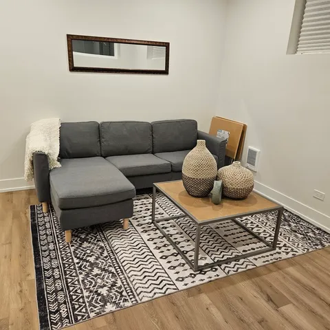 a living room with a couch and a rug