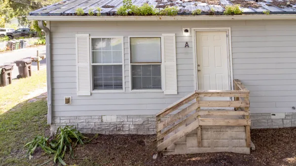 a front view of a house with a yard