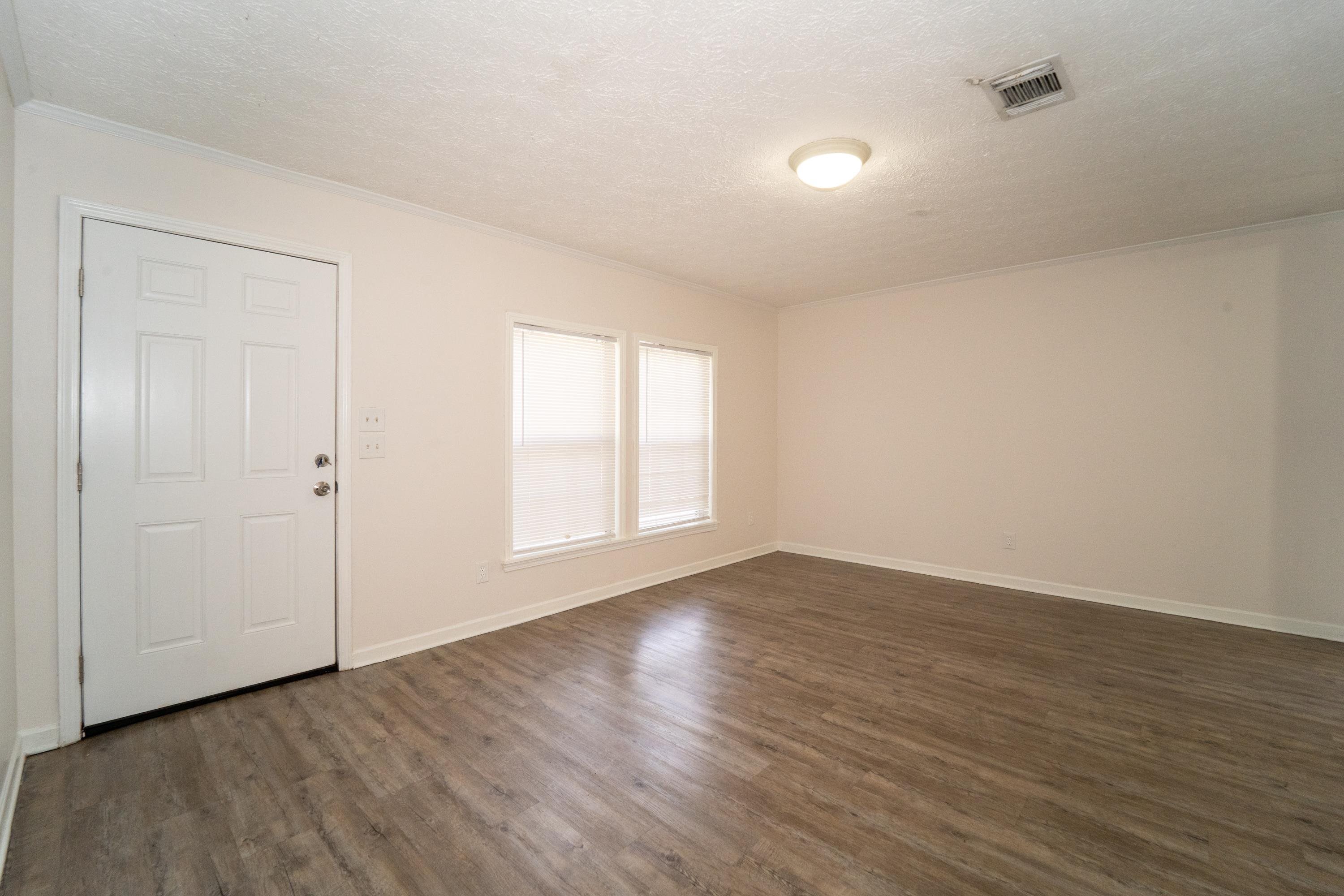 37 Evergreen Avenue, Unit A St. Augustine, FL 32084 - Photo 12 of 19 a view of an empty room with wooden floor and a window
