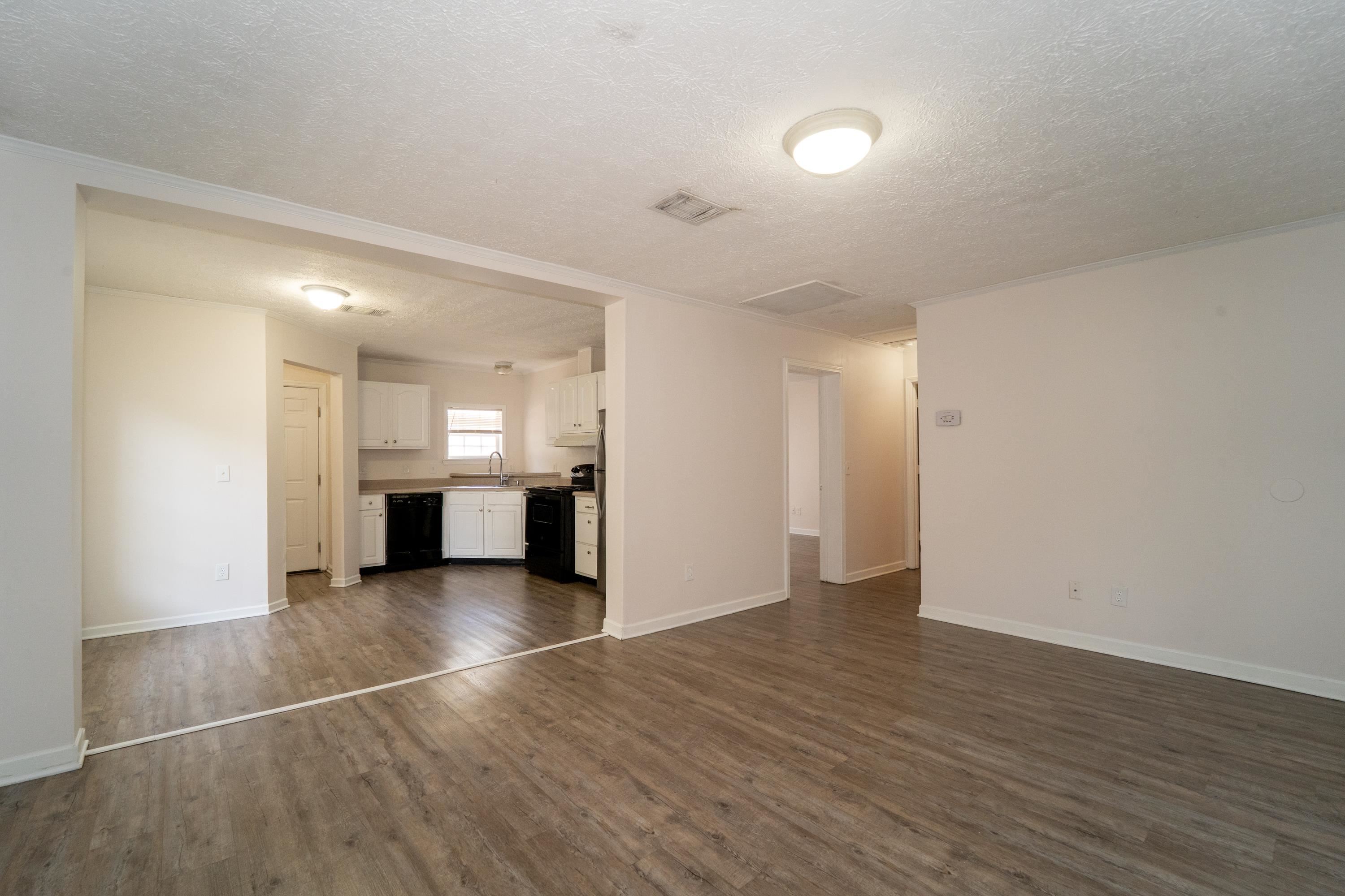 37 Evergreen Avenue, Unit A St. Augustine, FL 32084 - Photo 14 of 19 a view of an empty room with wooden floor and kitchen