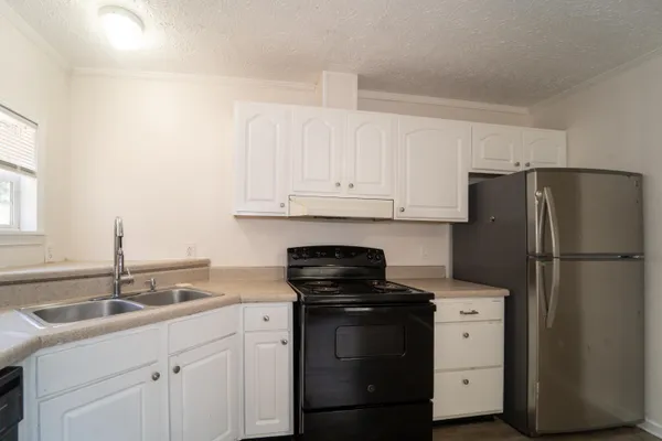 a kitchen with a sink stove and refrigerator