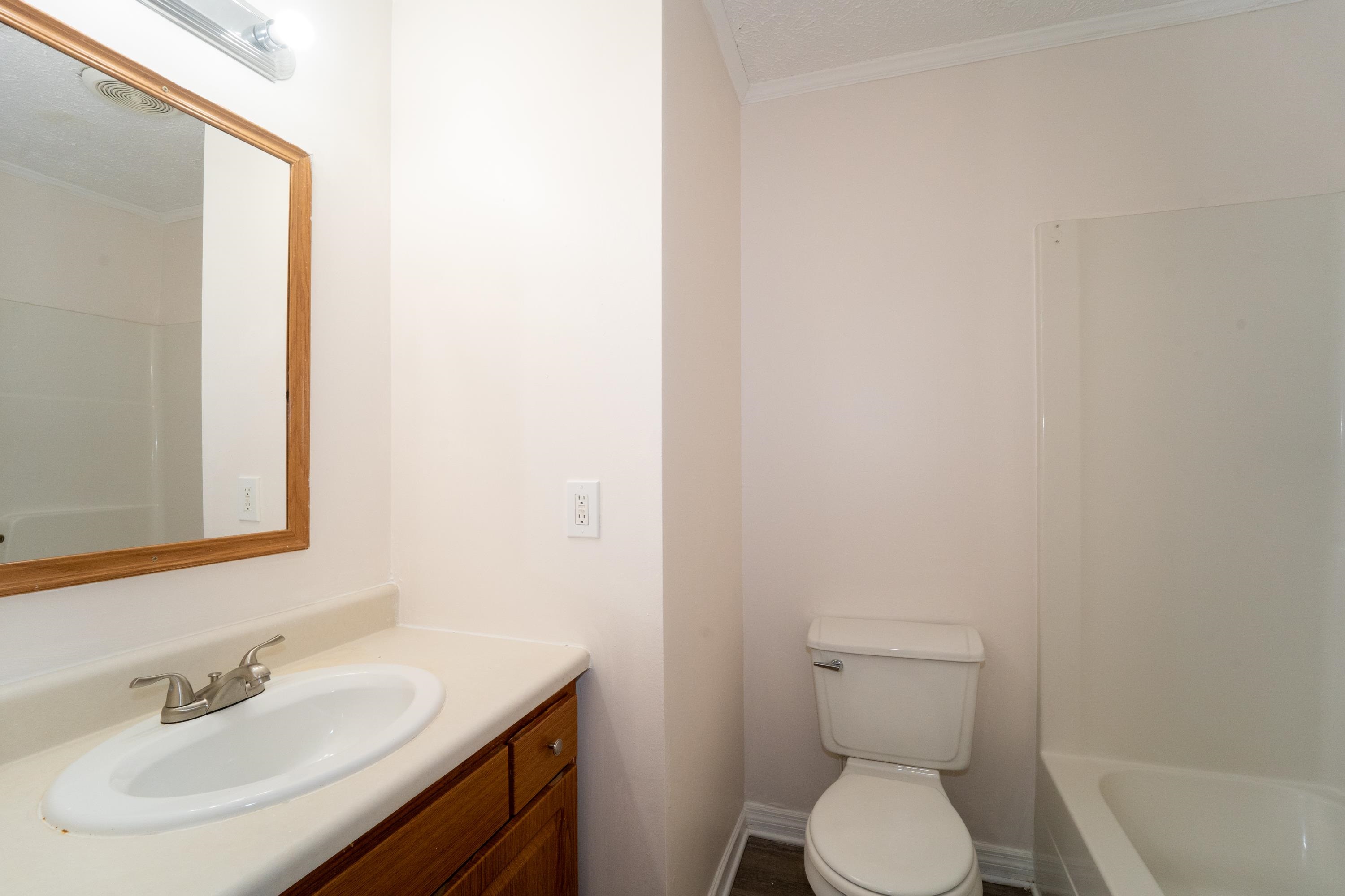37 Evergreen Avenue, Unit A St. Augustine, FL 32084 - Photo 10 of 19 a bathroom with a sink toilet and a mirror