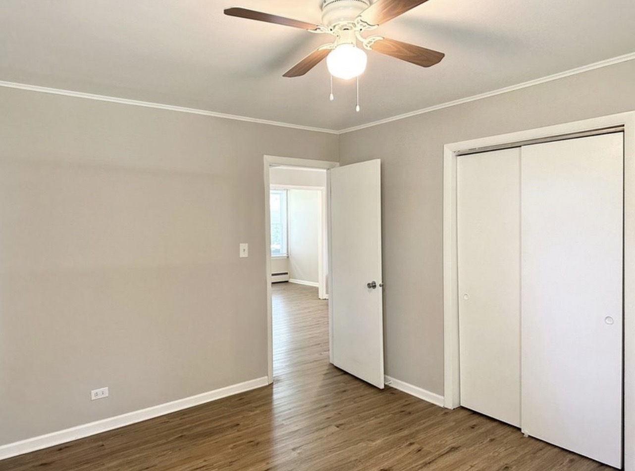 35339 North Hickory Lane Round Lake, IL 60073 - Photo 13 of 16 an empty room with wooden floor closet and fan