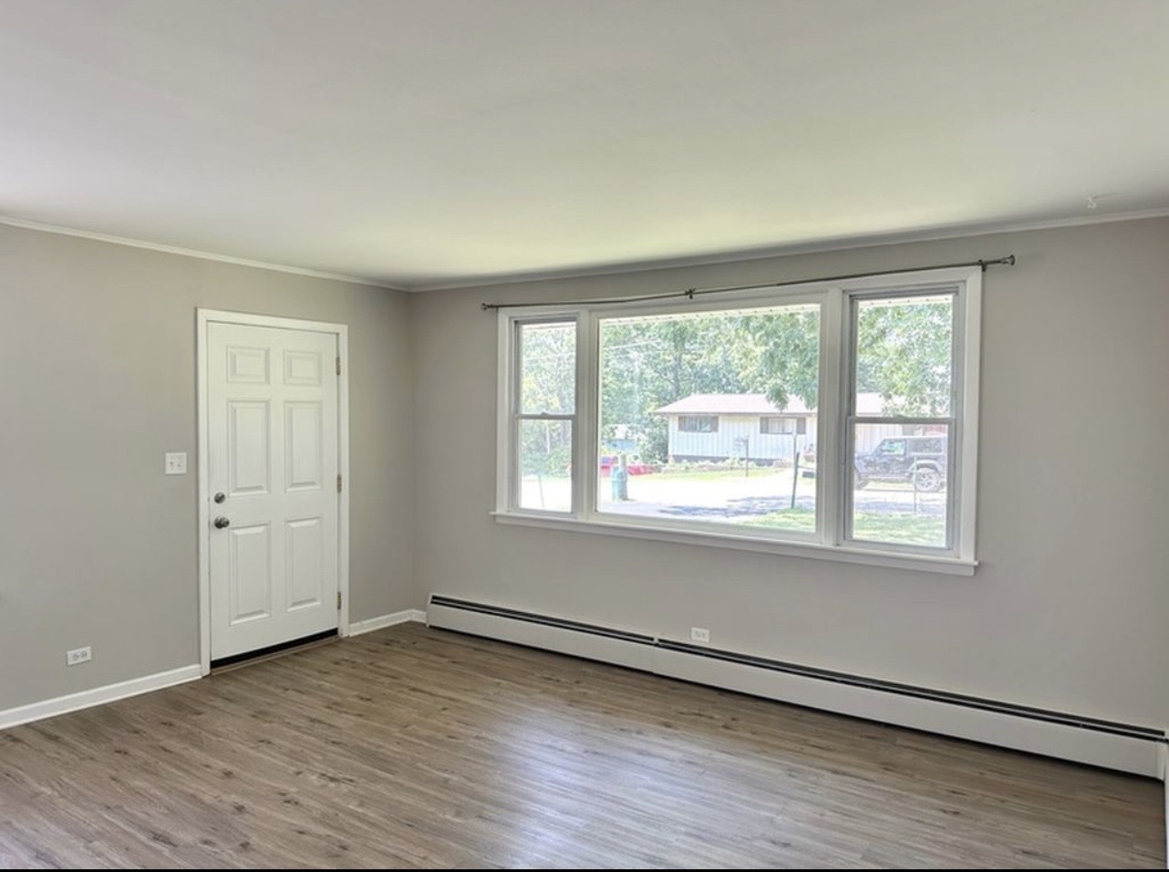 35339 North Hickory Lane Round Lake, IL 60073 - Photo 2 of 16 an empty room with wooden floor and windows