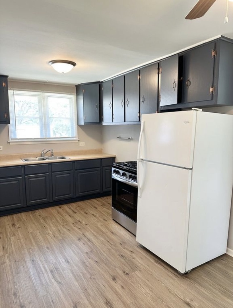 35339 North Hickory Lane Round Lake, IL 60073 - Photo 5 of 16 a kitchen with granite countertop a refrigerator a sink and a stove
