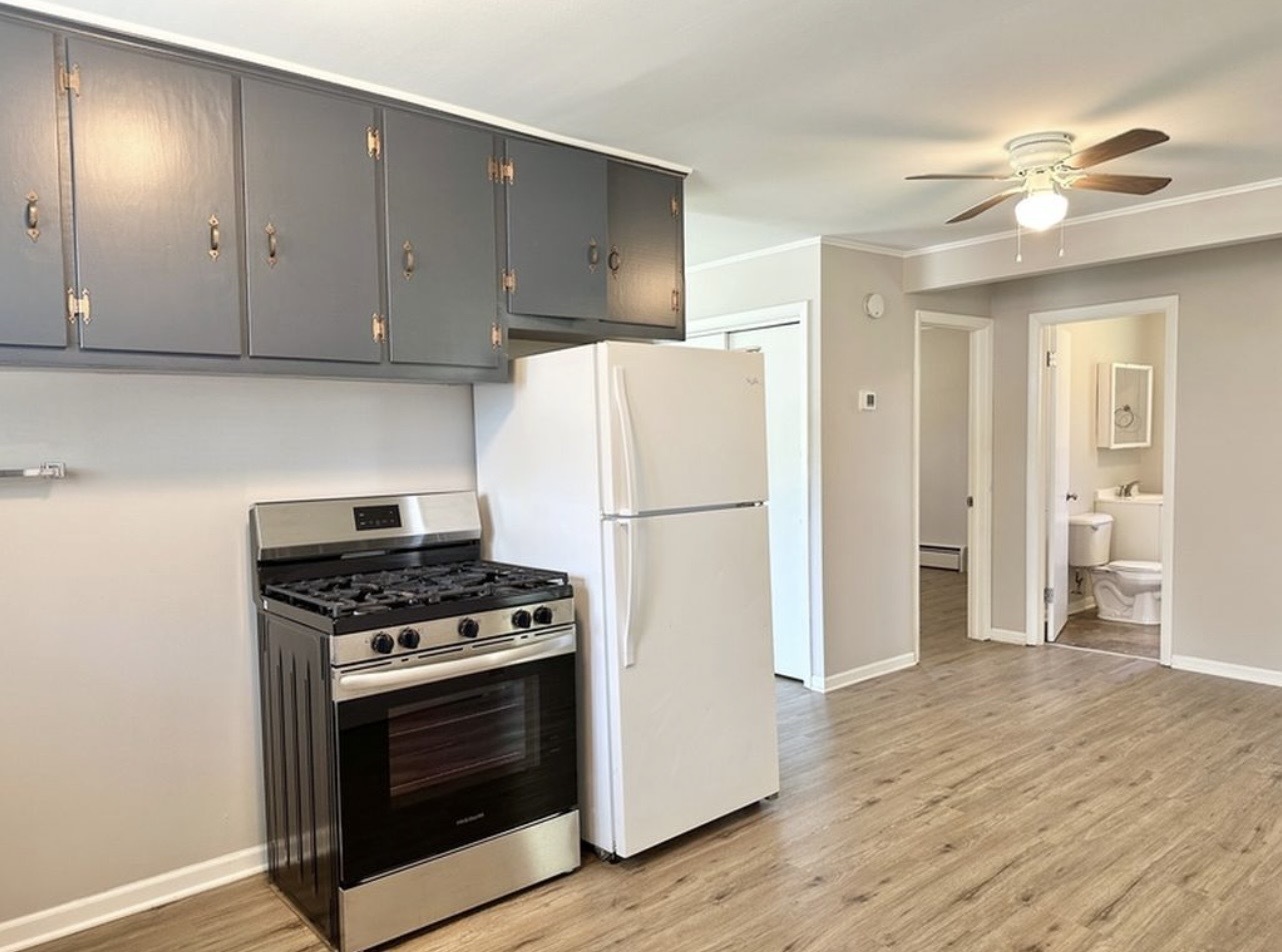 35339 North Hickory Lane Round Lake, IL 60073 - Photo 7 of 16 a kitchen with wooden cabinets and white appliances