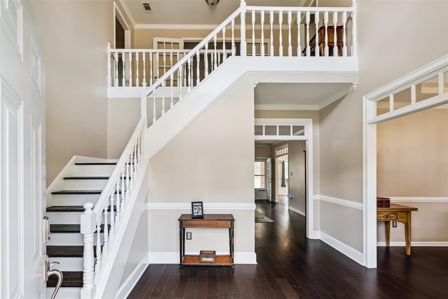 1489 John Ridge Drive Collierville, TN 38017 - Photo 6 of 39 a view of staircase with lots of frames on wall and wooden floor