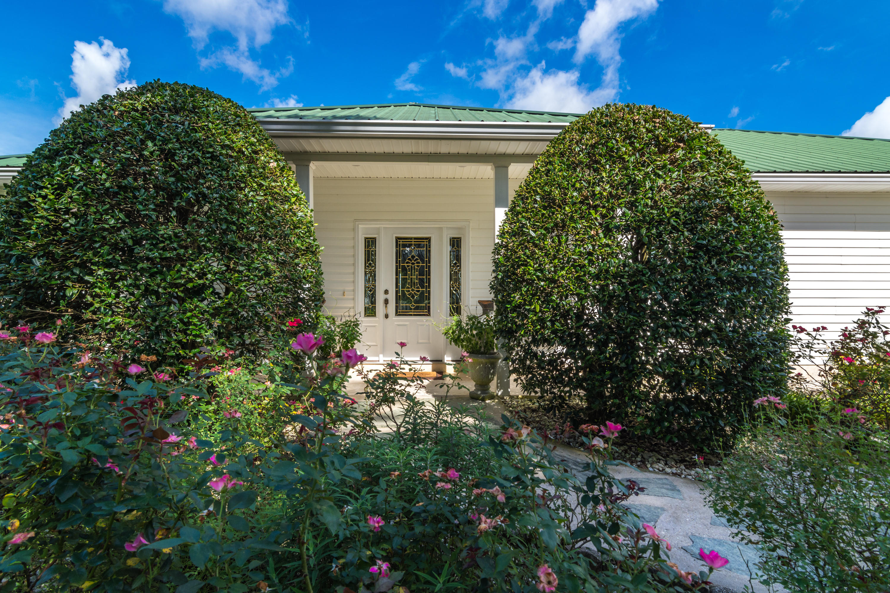 5676 Highway 2 DeFuniak Springs, FL 32433 - Photo 31 of 66 a view of a house with a flower garden