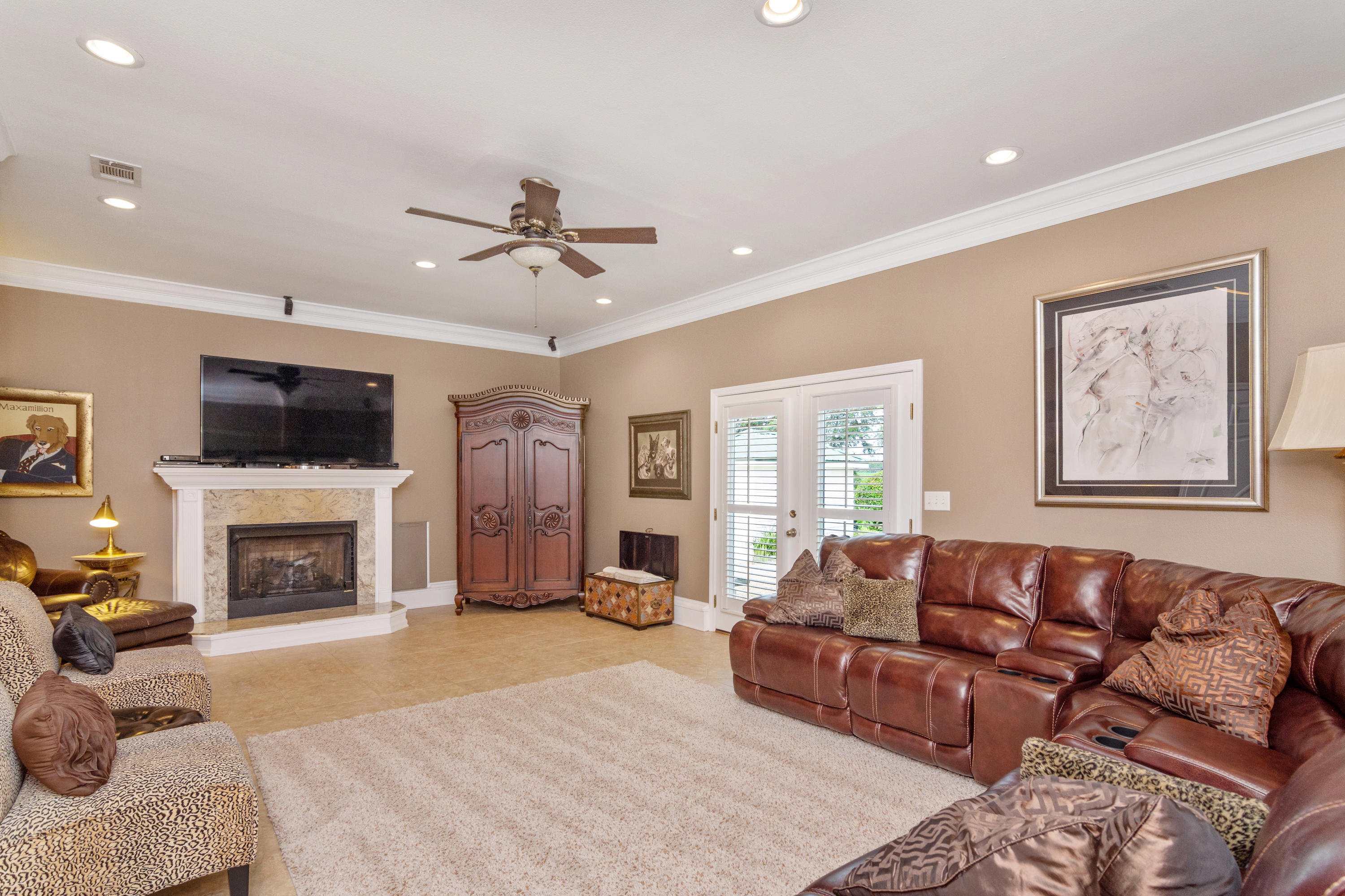 5676 Highway 2 DeFuniak Springs, FL 32433 - Photo 50 of 66 a living room with furniture a flat screen tv and a fireplace