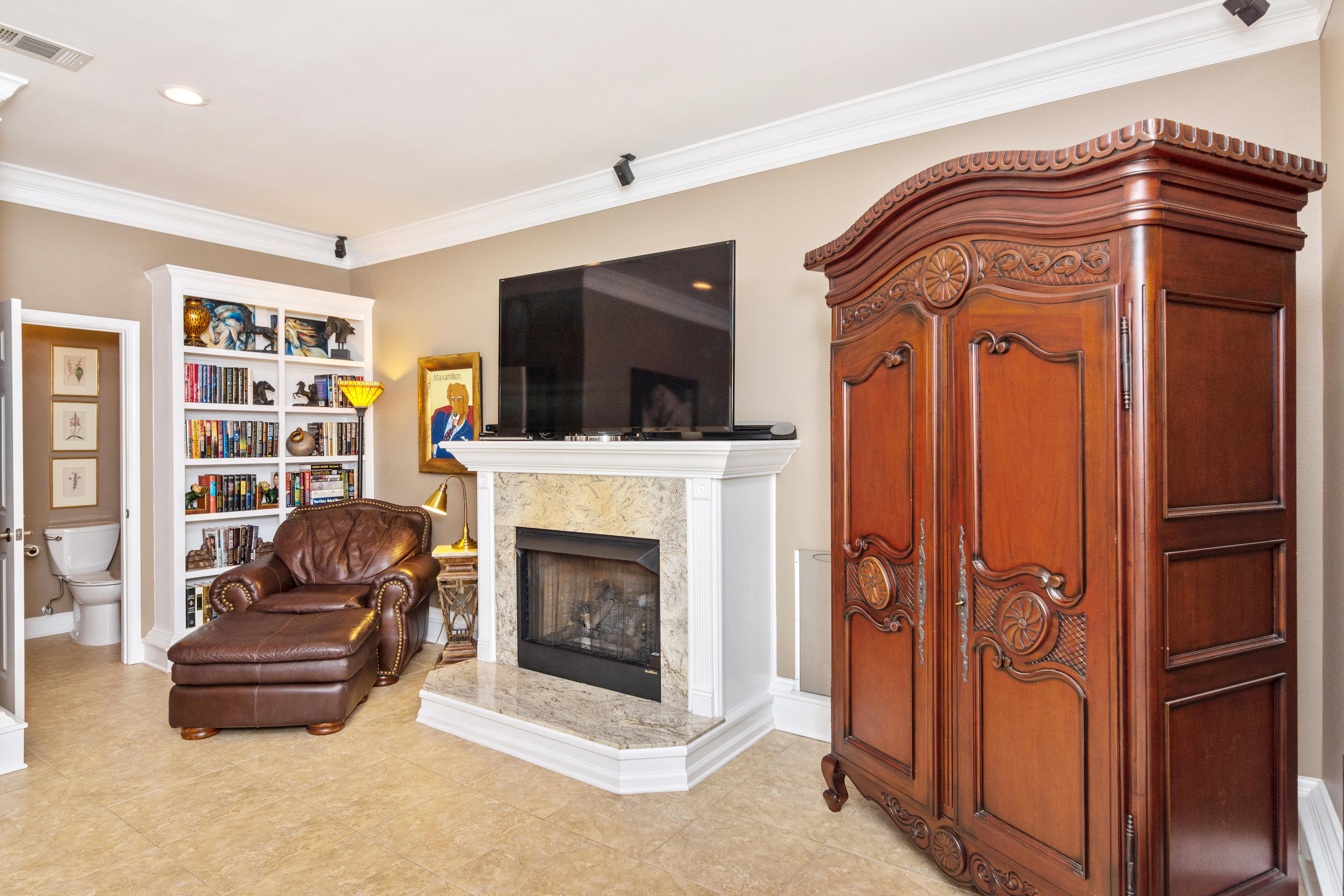 5676 Highway 2 DeFuniak Springs, FL 32433 - Photo 51 of 66 a living room with furniture a flat screen tv and a fireplace